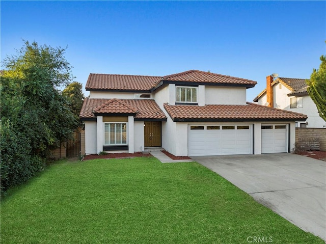 mediterranean / spanish house with a garage and a front lawn