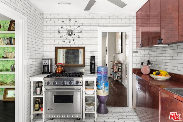 kitchen featuring ceiling fan, designer range, and decorative backsplash