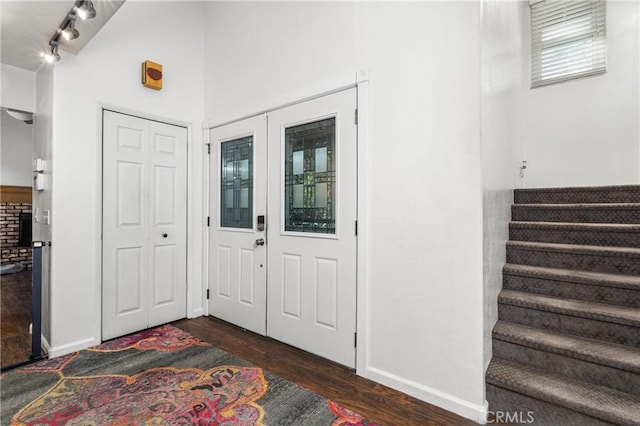 entryway featuring rail lighting and dark wood-type flooring