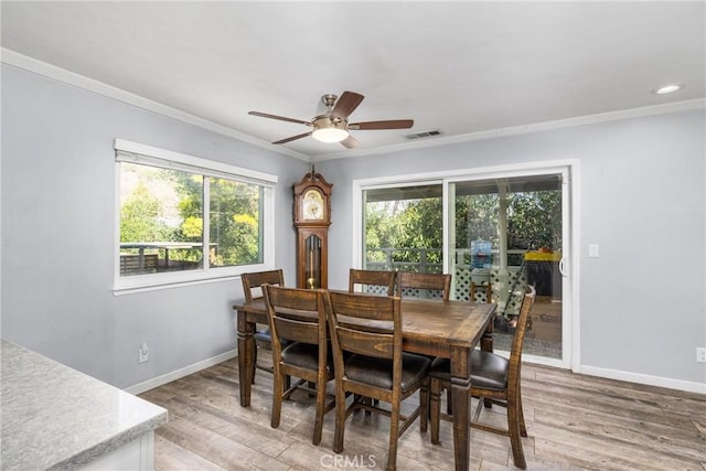 dining area with ornamental molding, ceiling fan, and hardwood / wood-style floors