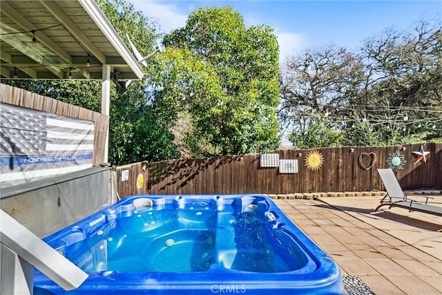 view of swimming pool featuring an outdoor hot tub