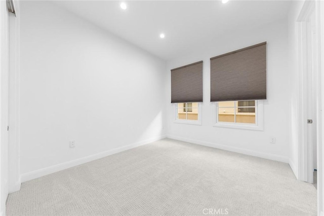 unfurnished room featuring light colored carpet