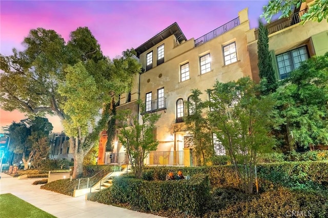 view of outdoor building at dusk