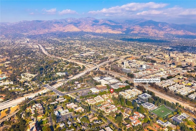 birds eye view of property with a mountain view