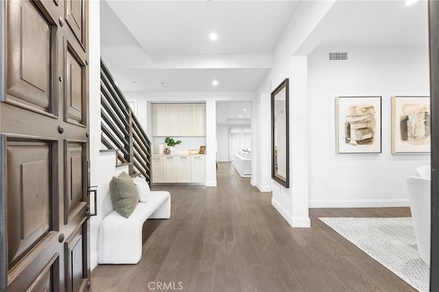 corridor with dark hardwood / wood-style flooring