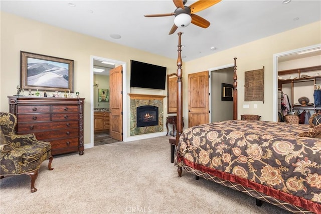 bedroom featuring ceiling fan, ensuite bathroom, a closet, and carpet