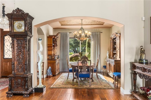 dining room with an inviting chandelier and wood-type flooring