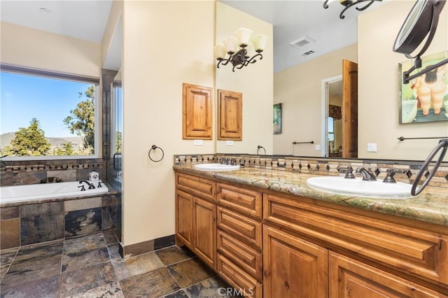 bathroom with vanity and tiled bath