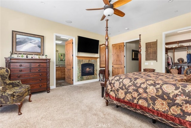 325 Red Oak Way, Arroyo Grande, CA 93420 - bedroom with carpet flooring, a glass covered fireplace, a walk in closet, connected bathroom, and a closet