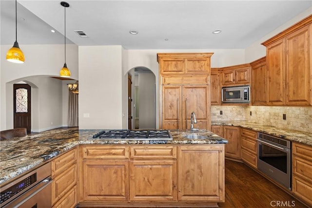 325 Red Oak Way, Arroyo Grande, CA 93420 - kitchen featuring arched walkways, appliances with stainless steel finishes, stone counters, tasteful backsplash, and recessed lighting