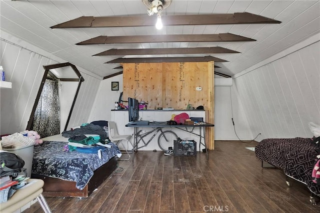 bedroom featuring dark hardwood / wood-style floors, wooden walls, and vaulted ceiling with beams