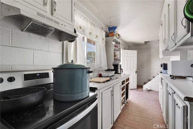 kitchen featuring white cabinetry, sink, and stainless steel electric stove