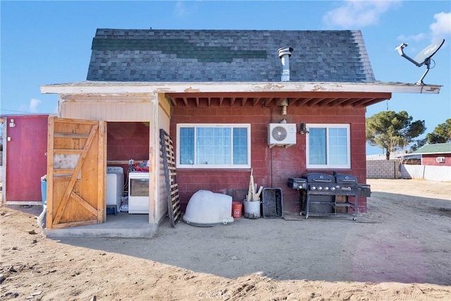 rear view of property with ac unit