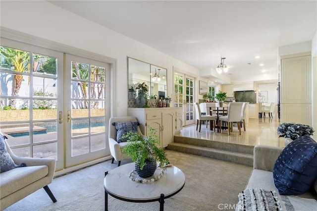 living room with french doors and light carpet