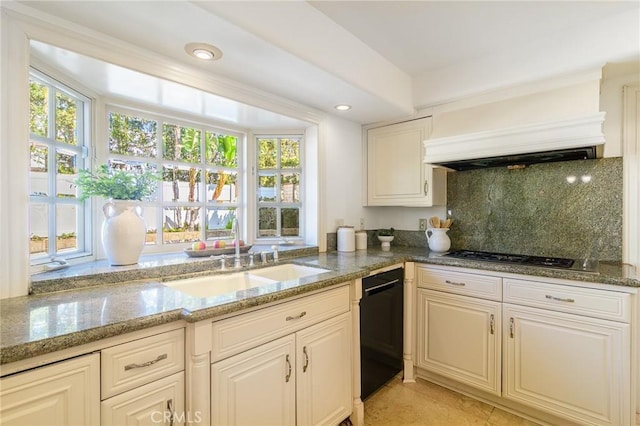 kitchen featuring custom exhaust hood, sink, light stone counters, and stainless steel gas cooktop