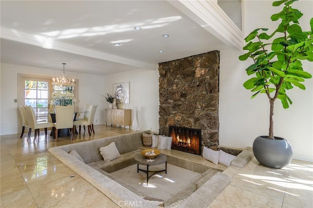 living room featuring crown molding, an inviting chandelier, and a fireplace