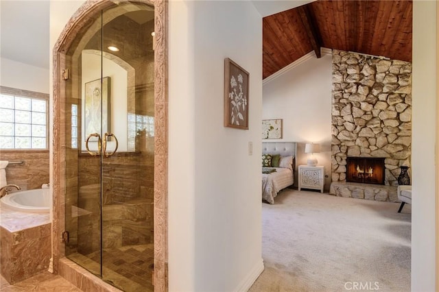 bathroom with separate shower and tub, vaulted ceiling with beams, a fireplace, and wood ceiling