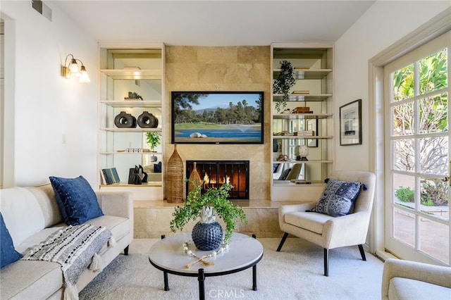 living room with a fireplace and built in shelves