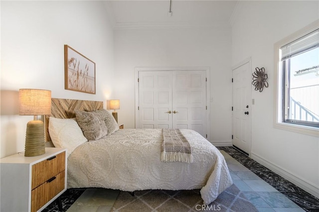 bedroom with multiple windows, crown molding, and a closet