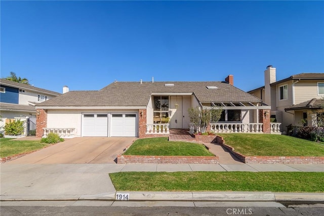 view of front of property with a garage and a front yard