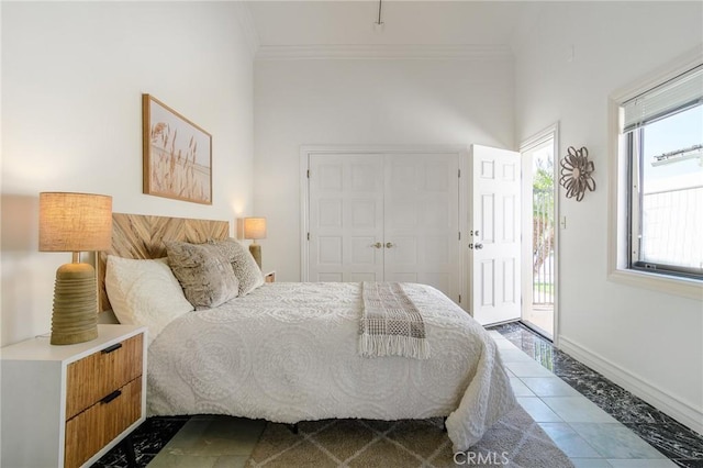 bedroom featuring ornamental molding, access to outside, and a closet