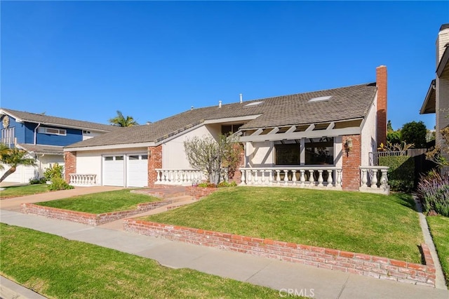 view of front of property with a garage and a front yard