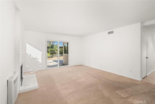 unfurnished room featuring light carpet