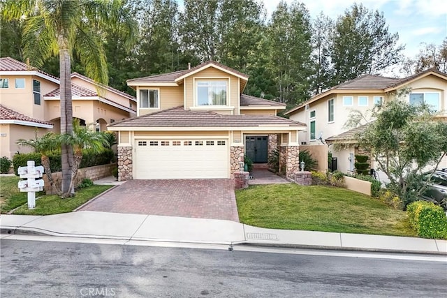 view of front of house with a front yard and a garage