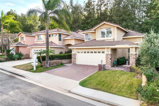 view of front of home with a garage and a front lawn