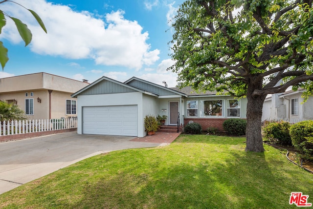 ranch-style house featuring a garage and a front yard