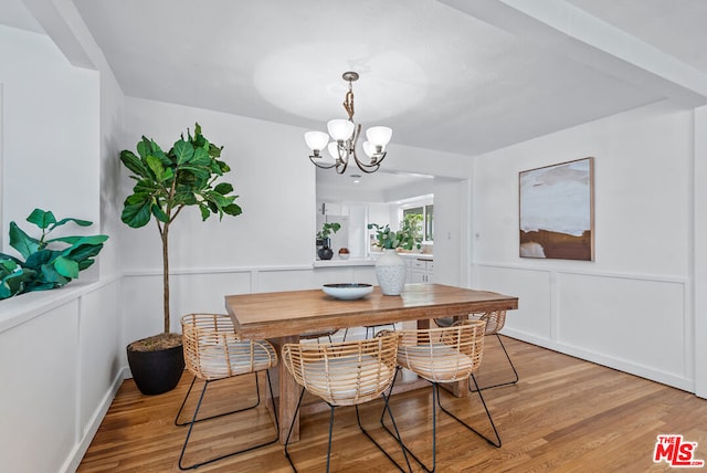 dining room with hardwood / wood-style floors and a notable chandelier