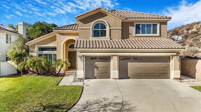 mediterranean / spanish house featuring a garage and a front lawn