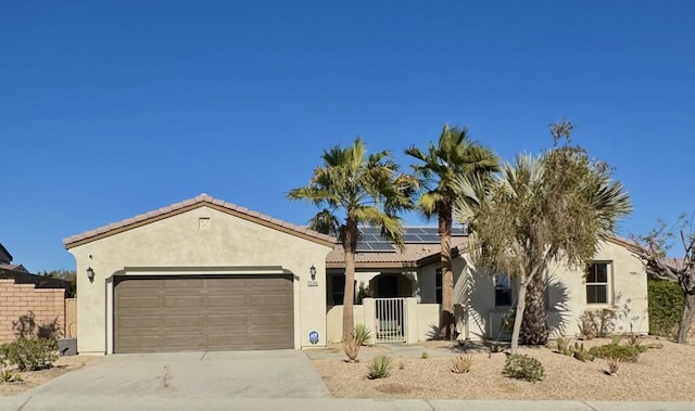 view of front of property featuring a garage and solar panels