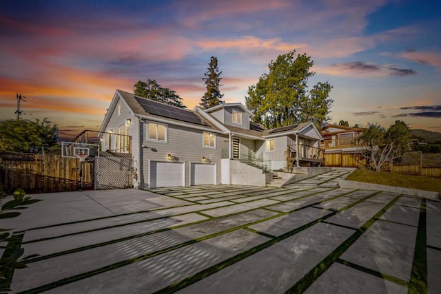 view of front of house with a garage and solar panels