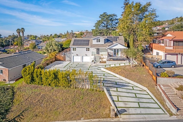 view of front of home featuring a garage and solar panels