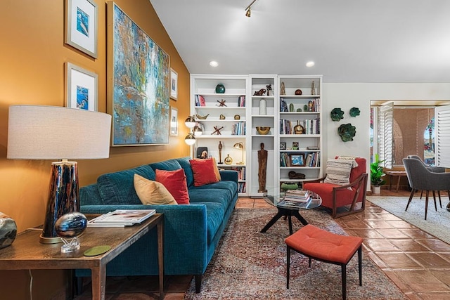 living room with lofted ceiling and track lighting