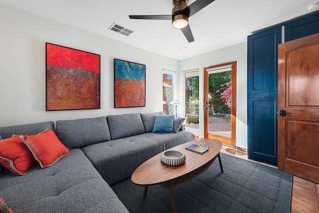 living room with ceiling fan and light hardwood / wood-style flooring