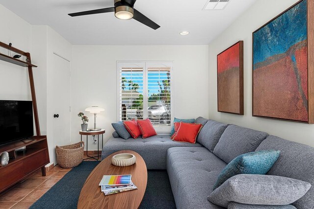 living room featuring light tile patterned floors and ceiling fan