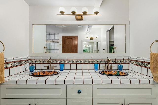 bathroom featuring vanity and decorative backsplash