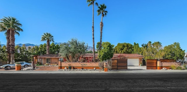 view of front of house with a garage and a mountain view