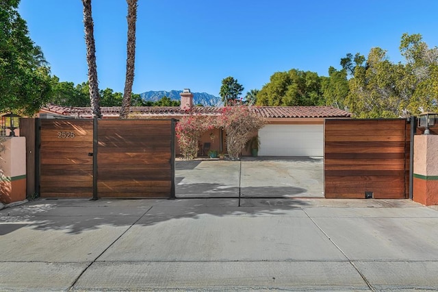 view of front of home with a mountain view and a garage