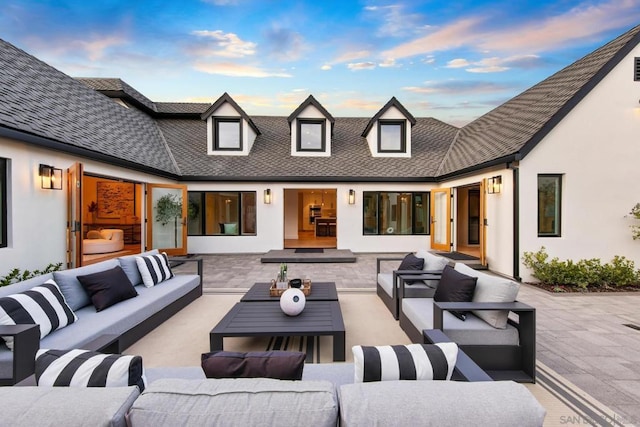 patio terrace at dusk featuring outdoor lounge area