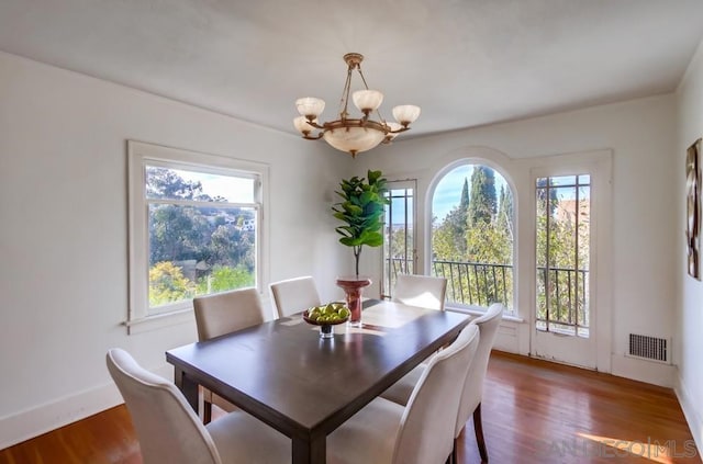 dining area featuring plenty of natural light and dark hardwood / wood-style floors