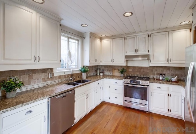 kitchen featuring light hardwood / wood-style floors, tasteful backsplash, white cabinetry, sink, and stainless steel appliances