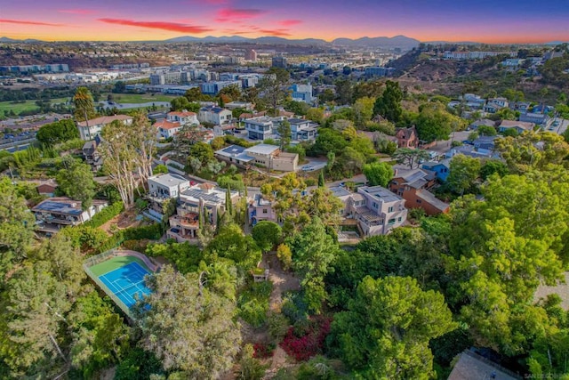 aerial view at dusk featuring a mountain view