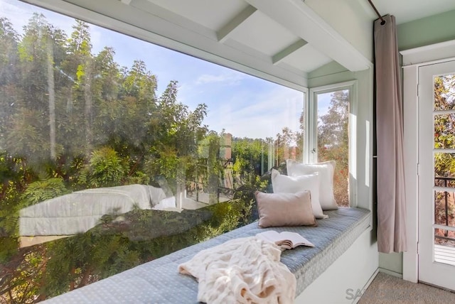 sunroom / solarium featuring beam ceiling