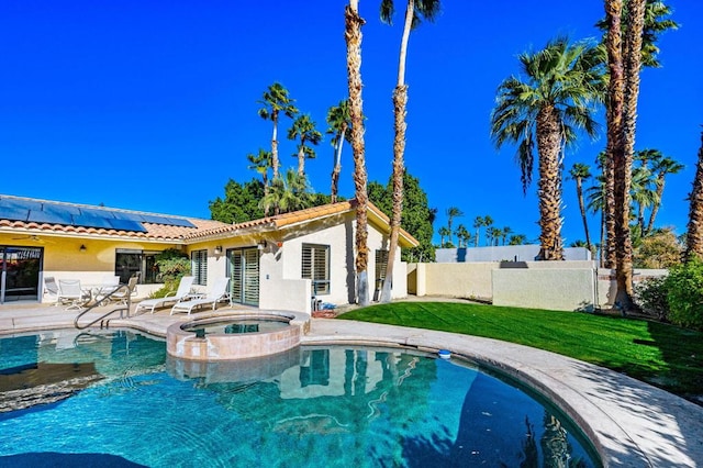 view of pool featuring an in ground hot tub and a lawn