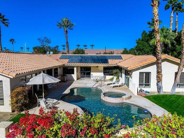 view of pool featuring an in ground hot tub and a patio area