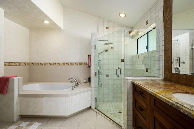 bathroom featuring vanity, tile walls, separate shower and tub, and tile patterned flooring