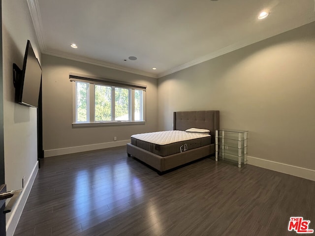 unfurnished bedroom with dark wood-type flooring and ornamental molding